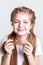 Joyful beaming little girl carrying ends of her long hair