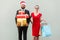 Joyful bearded business man in red hat and business woman in red