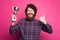 Joyful bearded man is holding a winner cup and thumb up