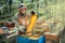 Joyful beekeeper holding a frame with honeycombs. Harvest of beekeeping products in the apiary.