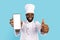 Joyful Black Chef Demonstrating Blank Smartphone And Showing Thumb Up At Camera