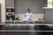 Joyful Black cook blogger dancing to music at kitchen table