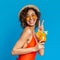 Joyful black girl in swimsuit enjoying summer cocktail and showing peace sign