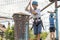 Joyful boy after overcoming obstacles on the cable car in the sports rope extreme park