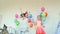 Joyful boys and girls dance in room with wigwam and balloons