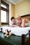 Joyful bride and groom in bedroom