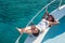 Joyful brunette woman laying on yacht deck