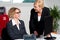 Joyful businesswomen enjoying at work desk