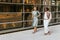 Joyful Businesswomen Strolling on the Street with Copy Space