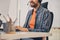 Joyful call center worker sitting at the table in office