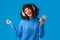 Joyful and carefree lovely african-american female model in winter sweater, dancing to rhythm music, listening new track