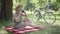 Joyful Caucasian middle aged woman taking photos on camera in sunny summer park. Portrait of happy carefree lady