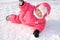 The joyful child lays on a snow