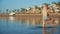 Joyful child walking out of water to sea coastline in summer evening.