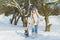 Joyful children playing in snow. Two happy girls having fun outside winter day