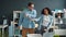 Joyful colleagues male and female dancing in office having fun indoors together