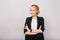 Joyful confident blonde businesswoman in suit smiling to camera isolated on white background. Modern worker, secretary