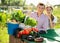 Joyful couple with a basket of vegetables in the garden