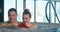 Joyful couple laughs and hugs sitting in whirlpool water