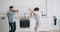 Joyful couple man and woman dancing at home in kitchen having fun together