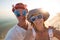 Joyful couple of travelers in funny sunglasses taking selfie