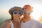 Joyful couple of travelers, in funny sunglasses, taking selfie