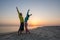 Joyful couple of travelers having fun on the beach