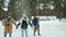 Joyful couples ice skating chatting laughing enjoying outdoor dates in winter park