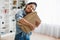 Joyful Customer Woman Holding Cardboard Box And Hugging It Indoors