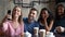 Joyful diverse mates company posing for group selfie at cafe