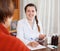 Joyful doctor examining patient