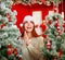 Joyful dreamy Santa woman on background Christmas tree with decor