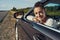 Joyful driver looking out of car window