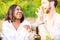 Joyful Duo: Mixed Race Couple Laughs Amidst Garden Party Festivities