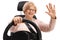 Joyful elderly woman sitting in a car seat and waving