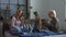 Joyful family with child playing cards on the bed