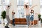 Joyful family enjoying dancing party in living room.