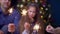 Joyful family holding bengal lights at christmas