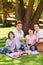 Joyful family picnicking in the park