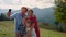 Joyful family taking selfie with sticking tongues on hill. Parents kids have fun