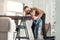 Joyful father helping his son measure the table