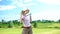 Joyful female golf player with club gesturing yes sign rejoicing successful shot