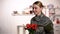 Joyful female sergeant rejoicing tulips bouquet and smiling homecoming after war
