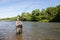 Joyful fisherman pulls caught salmon