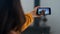 Joyful friends calling videochat on trip. Closeup girl waving smartphone screen