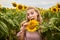 Joyful girl in a field with sunflowers. Good mood concept. Sunflower and sunflower oil products