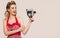 Joyful girl in pin-up style holds retro camera in her hand