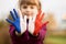 Joyful girl waving hands painted in France flag colors and say hello outdoor at sunset