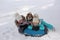 Joyful girls ride a tubing from a hill together. Winter holiday