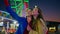 Joyful girls take selfie at amusement theme park. Happy best friends make photo